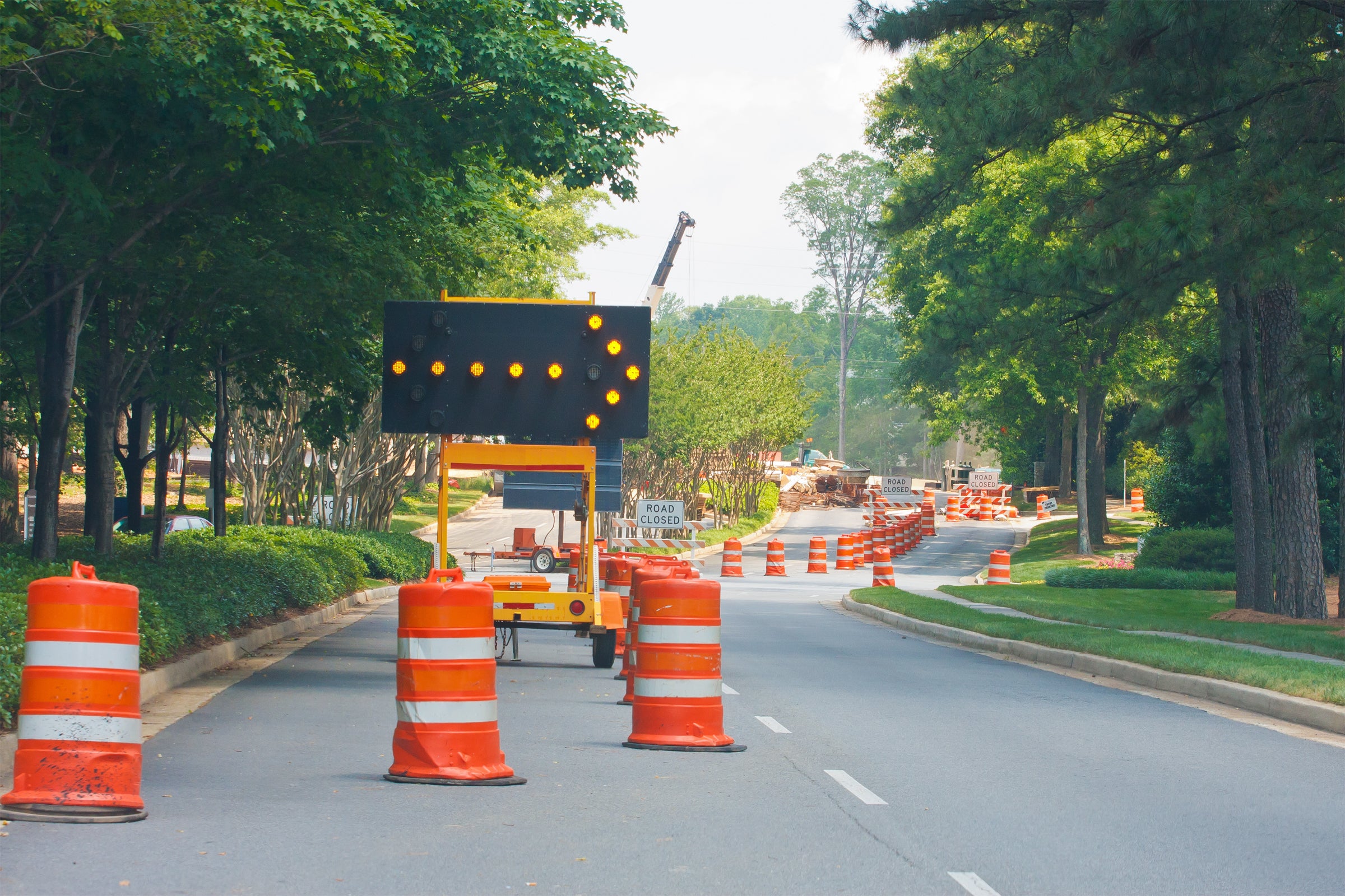 Road Construction with Channelizer Drums Redirecting Traffic Image