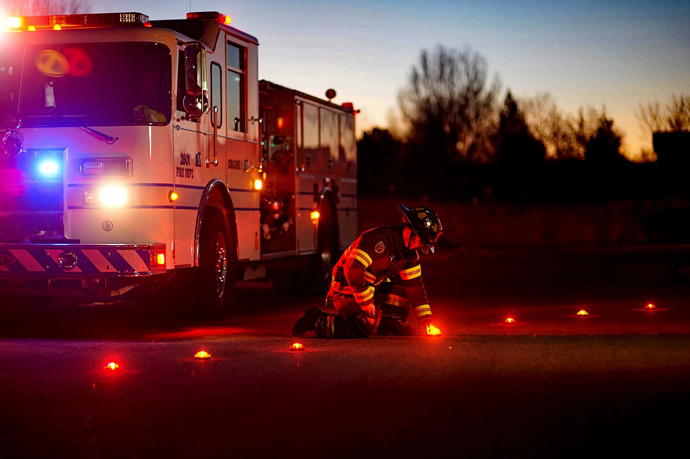 First Responder Placing LED Flares on the Road at Night Image