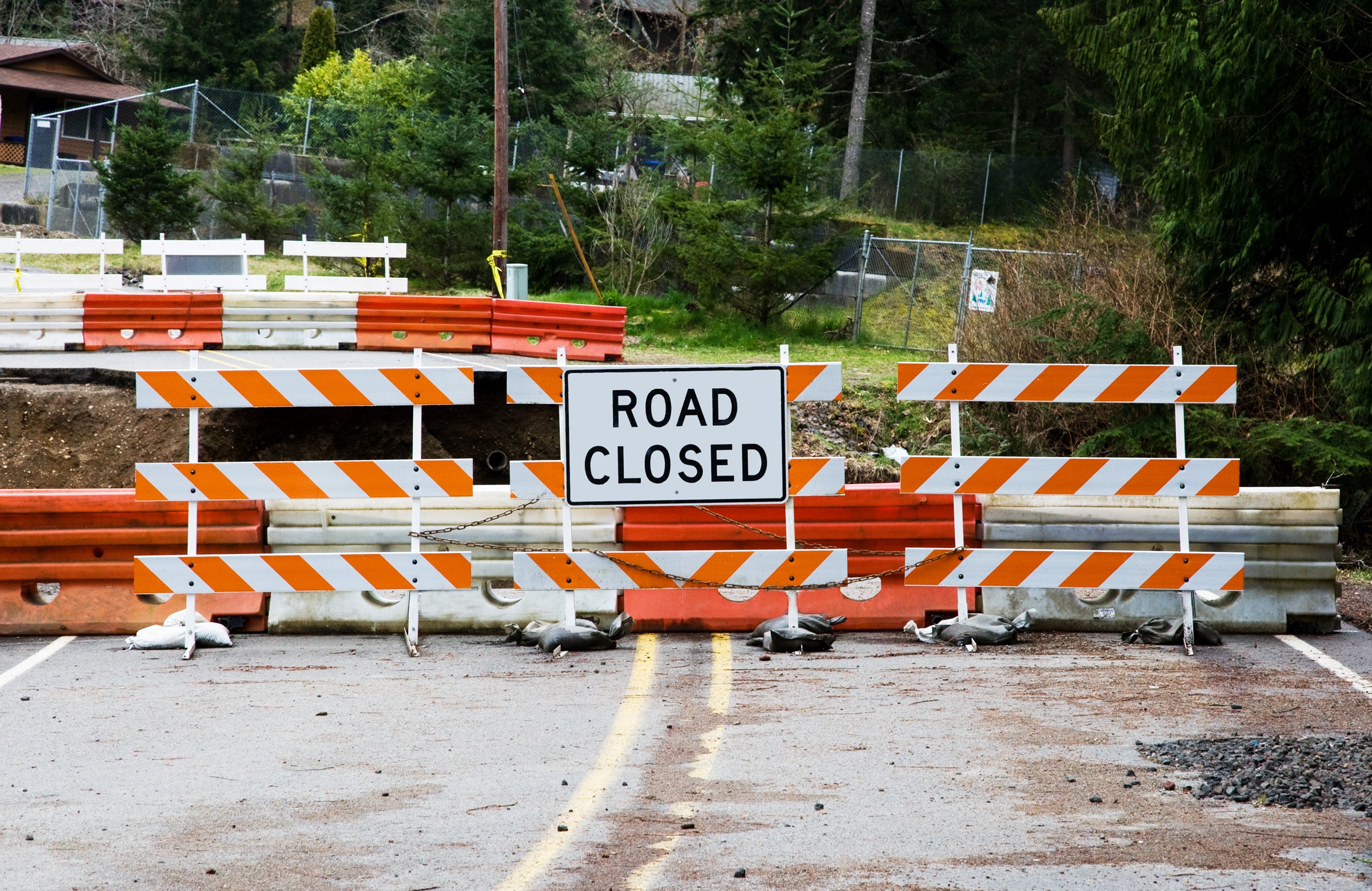 Board Barricades and Plastic Barriers Blocking Closed Road Image