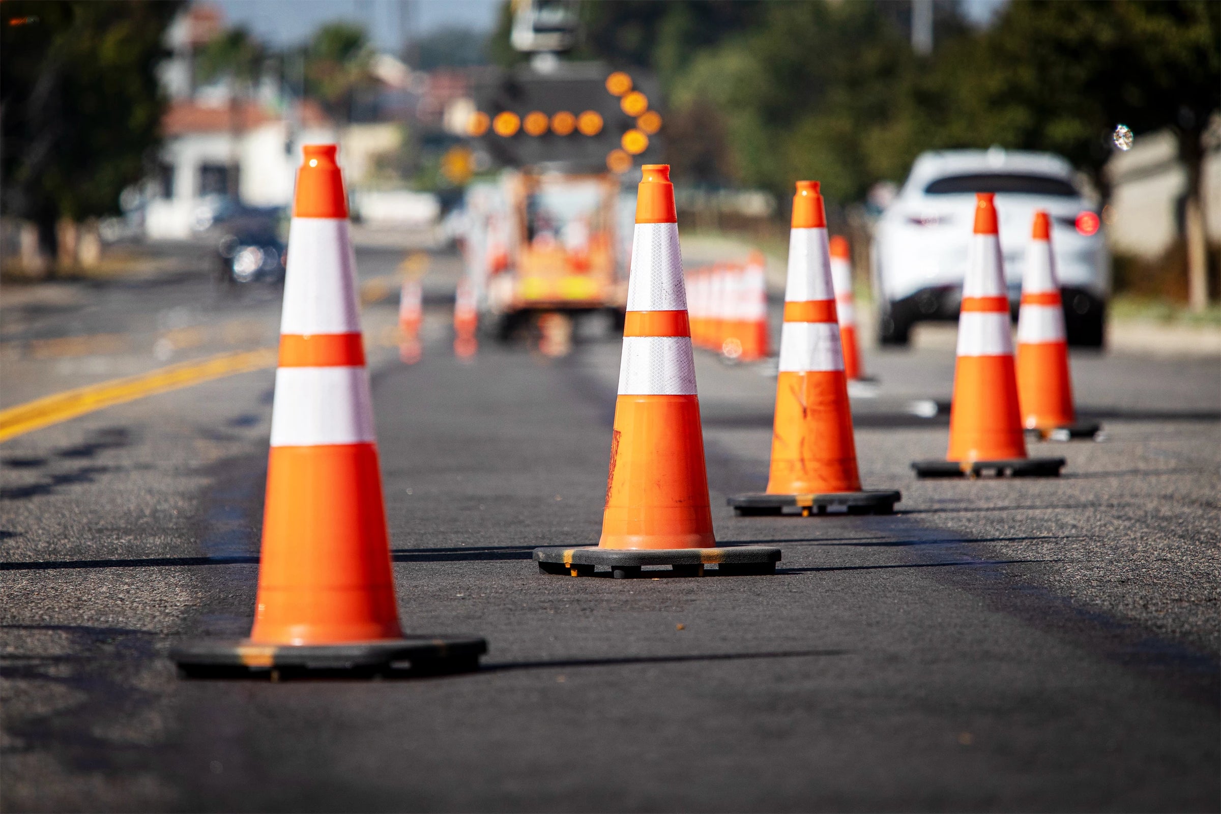 Traffic Cones with Reflective Bands in Orange on a Roadway Image