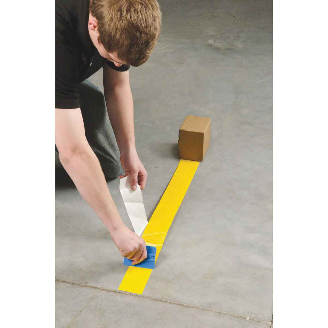 Solid Color Tough Stripe Tape Being Applied to Floor Image