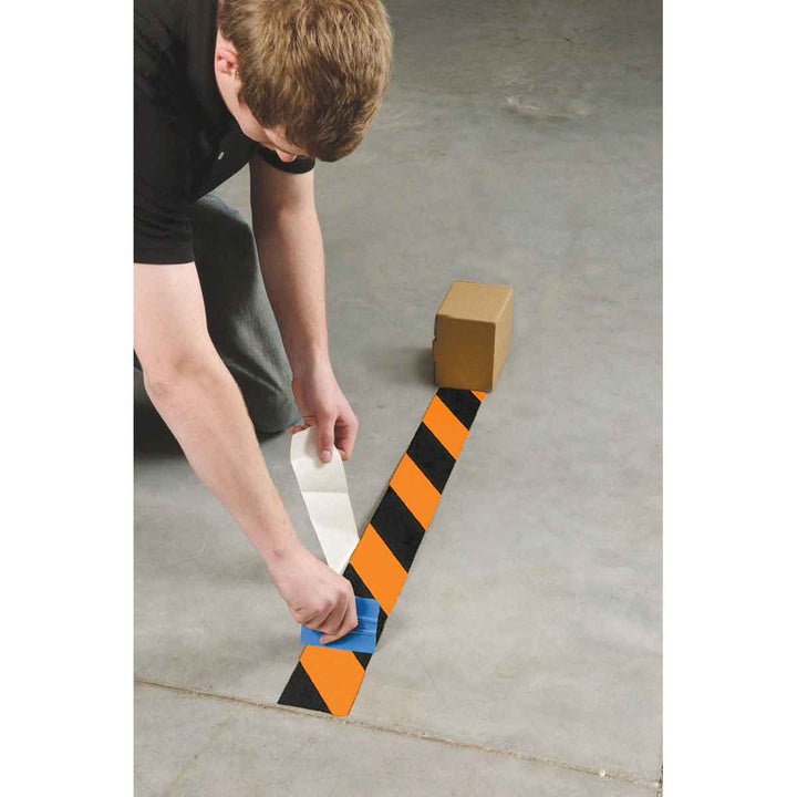 Striped ToughStripe® Tape Being Applied to Floor Image